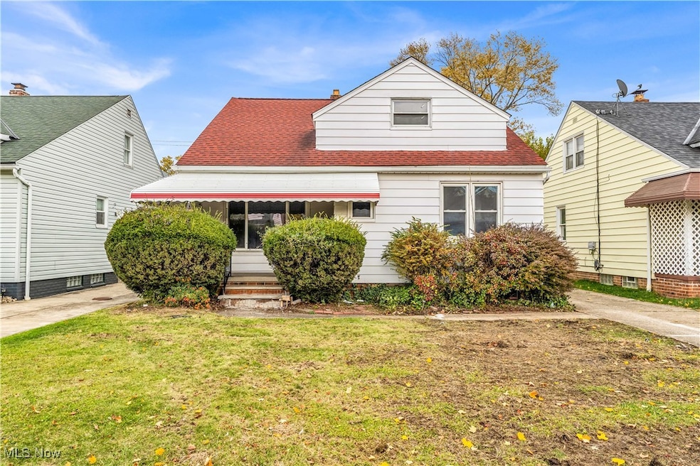 Bungalow-style home featuring a shingled roof and a front yard