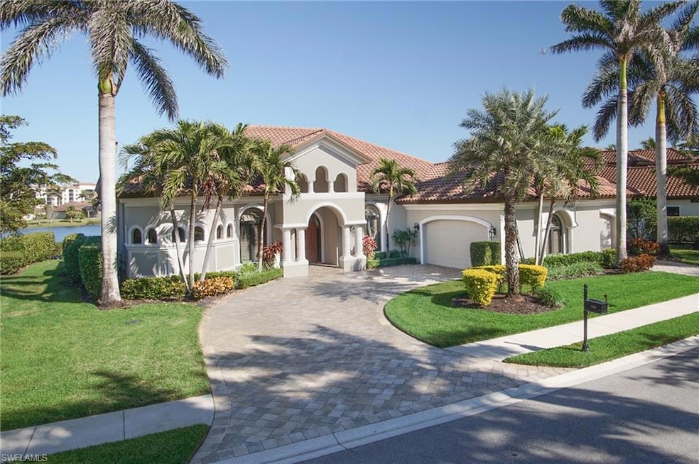 Mediterranean / spanish-style home featuring a garage and a front lawn
