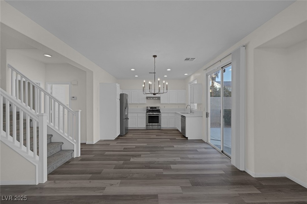 Kitchen with a notable chandelier, appliances with