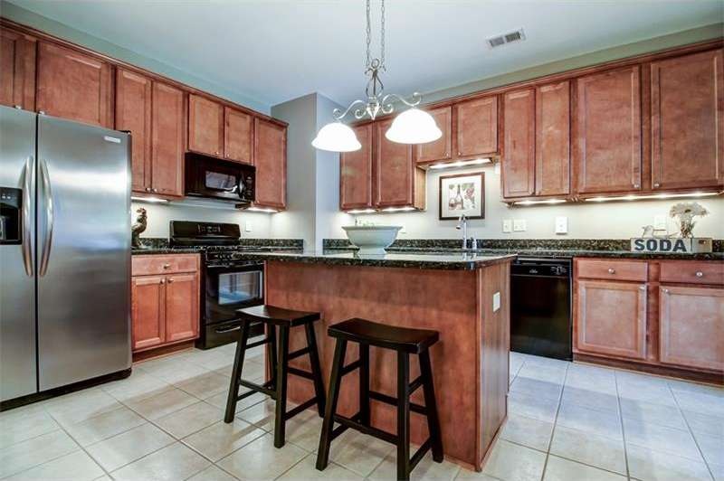 Spacious kitchen features granite counters, under 