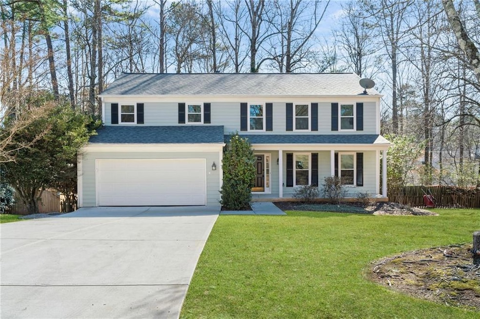 View of front facade featuring a garage, a porch, 