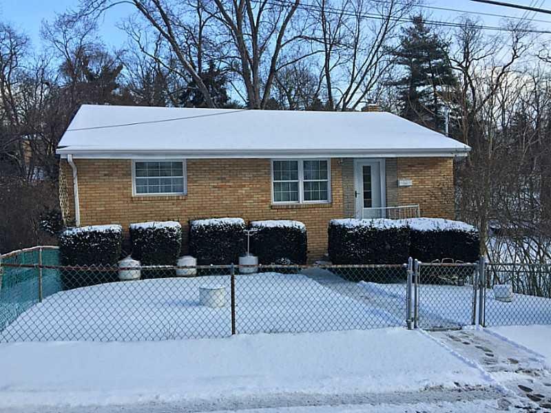 Exterior Front. Fenced-in front yard.