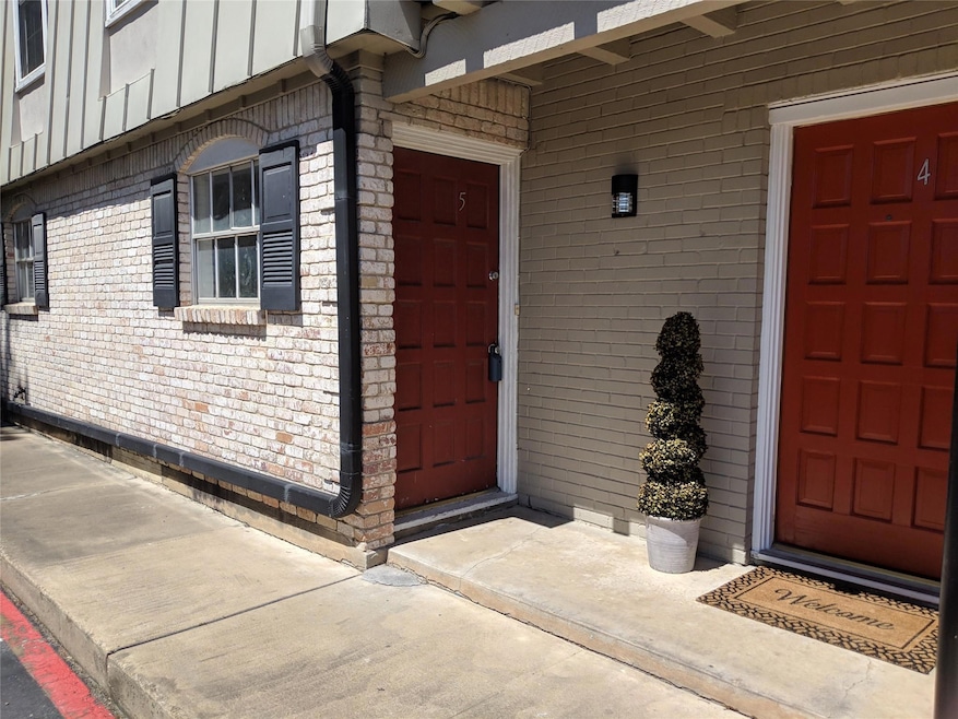 Doorway to property with brick siding and board a
