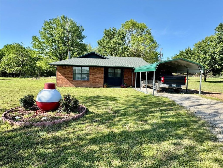 View of front of property featuring driveway, a ca