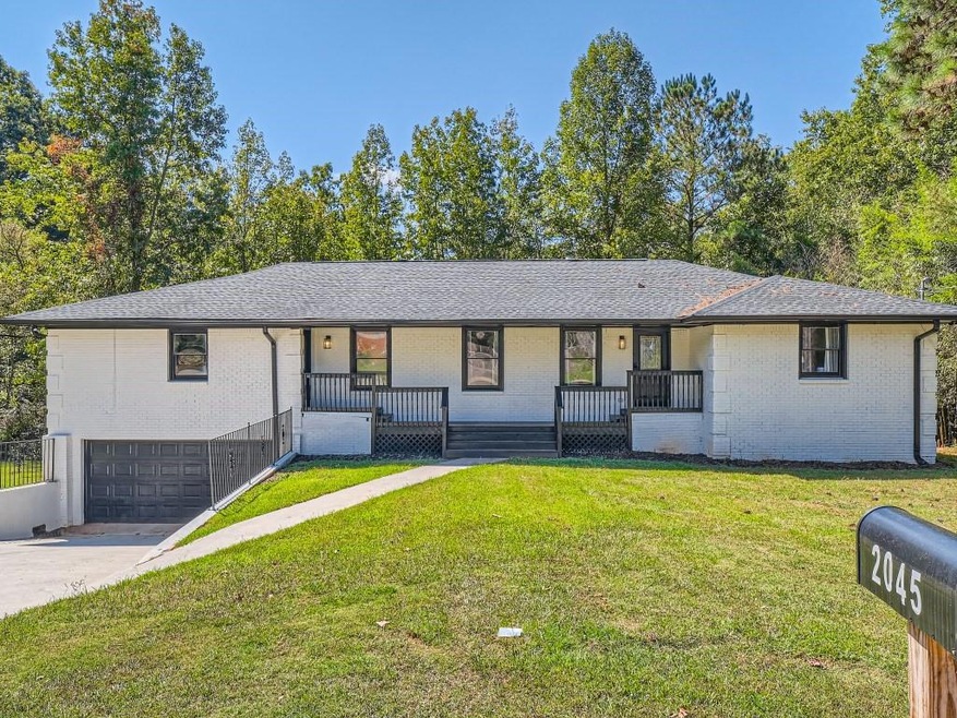 Ranch-style home with a garage and a front yard