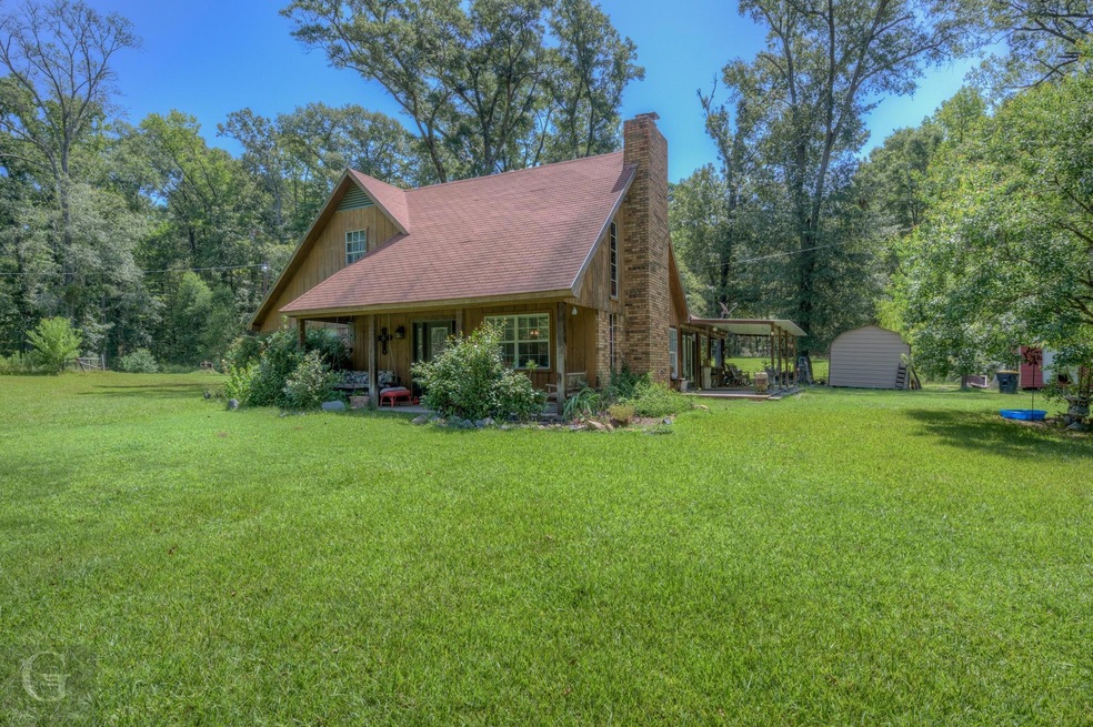 View of home's exterior with a yard and a storage 