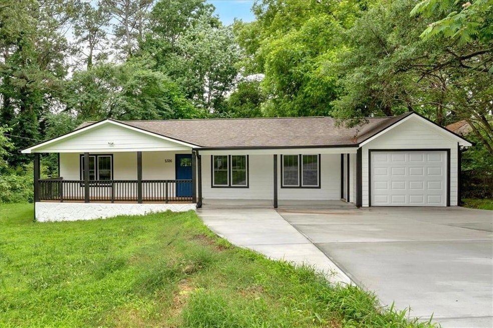 Ranch-style house with a porch, an attached garage, concrete driveway, and a front lawn