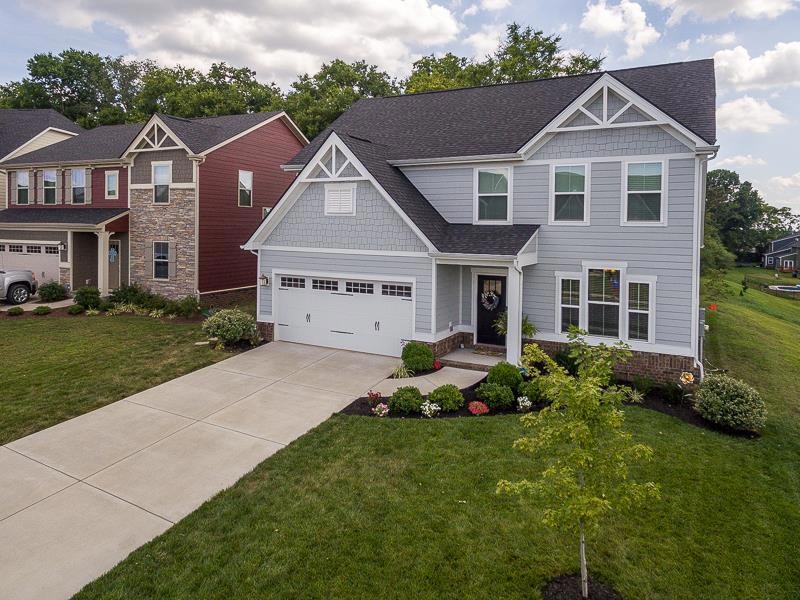 Like-new home on a premium lot that borders a tree line with extra green space beside