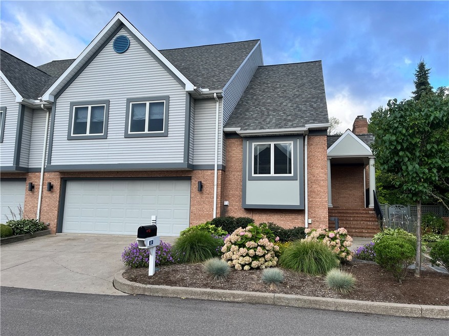 Curbside view of condo with attached garage