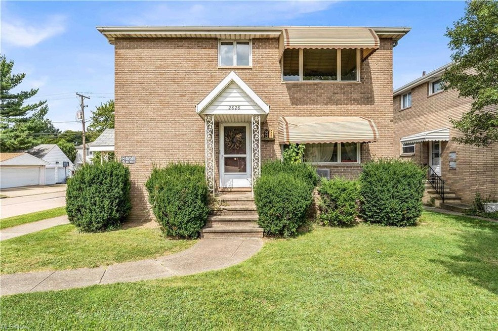 View of front of home with garage and a front lawn