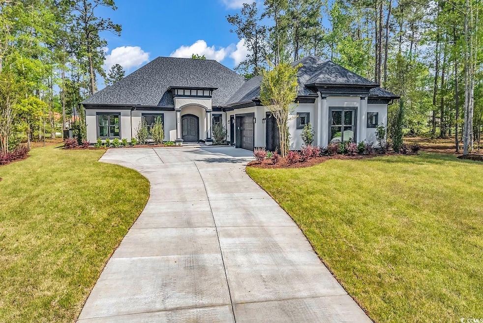 French country inspired facade with concrete drive