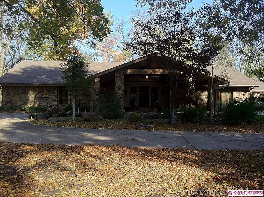 Front view of home. Circle drive. Large lot with l