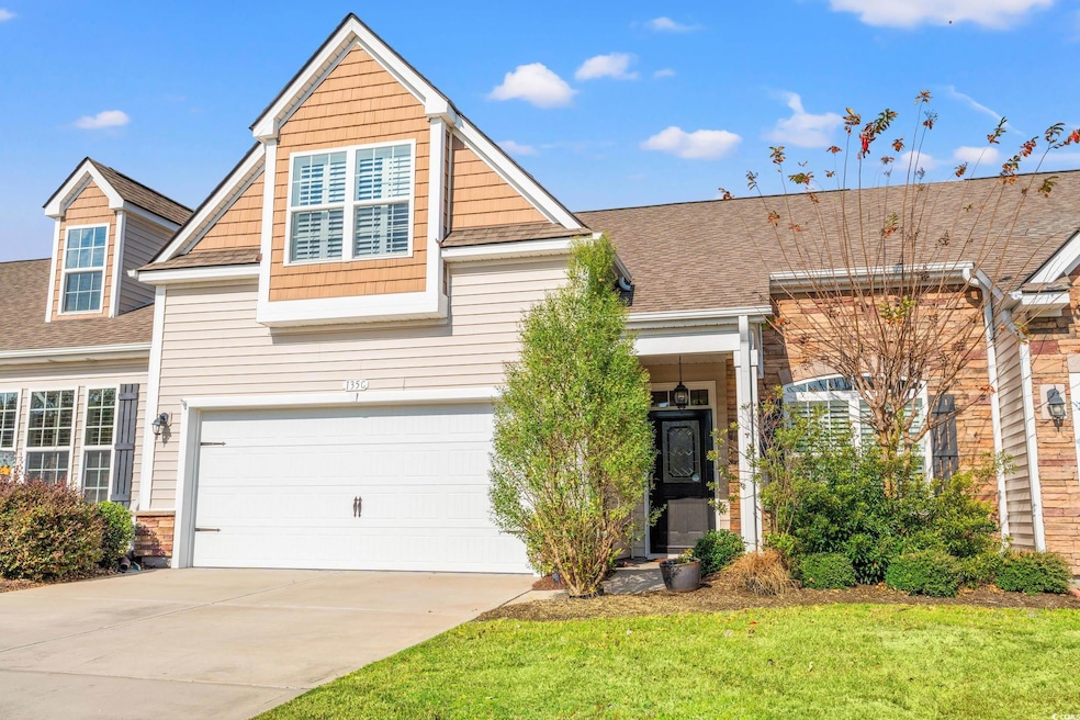 View of front of property with concrete driveway, a shingled roof, an attached garage, and a front lawn