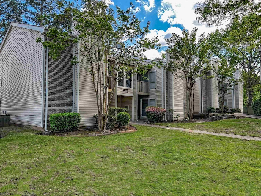 View of front of home with a front lawn and a balc