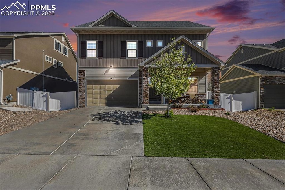 View of front of home with fence, an attached gara