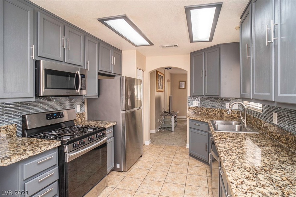 Kitchen features granite counter tops, back splash
