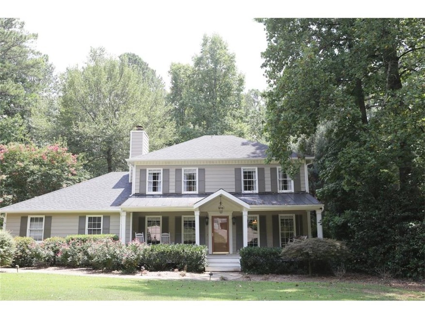 Inviting Front Porch with Swing and Rocking Chairs