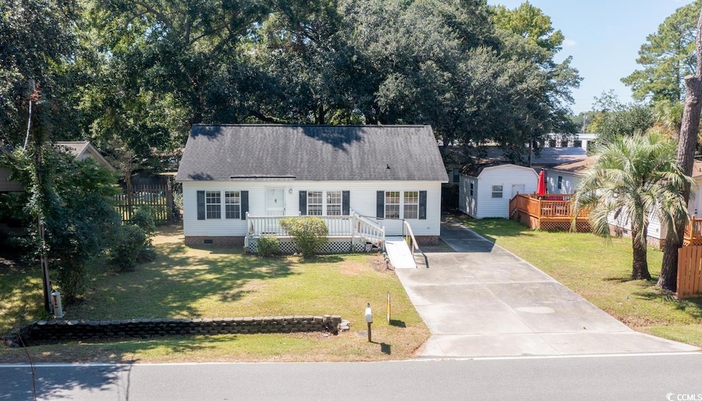 View of front of home featuring a wooden deck, a f