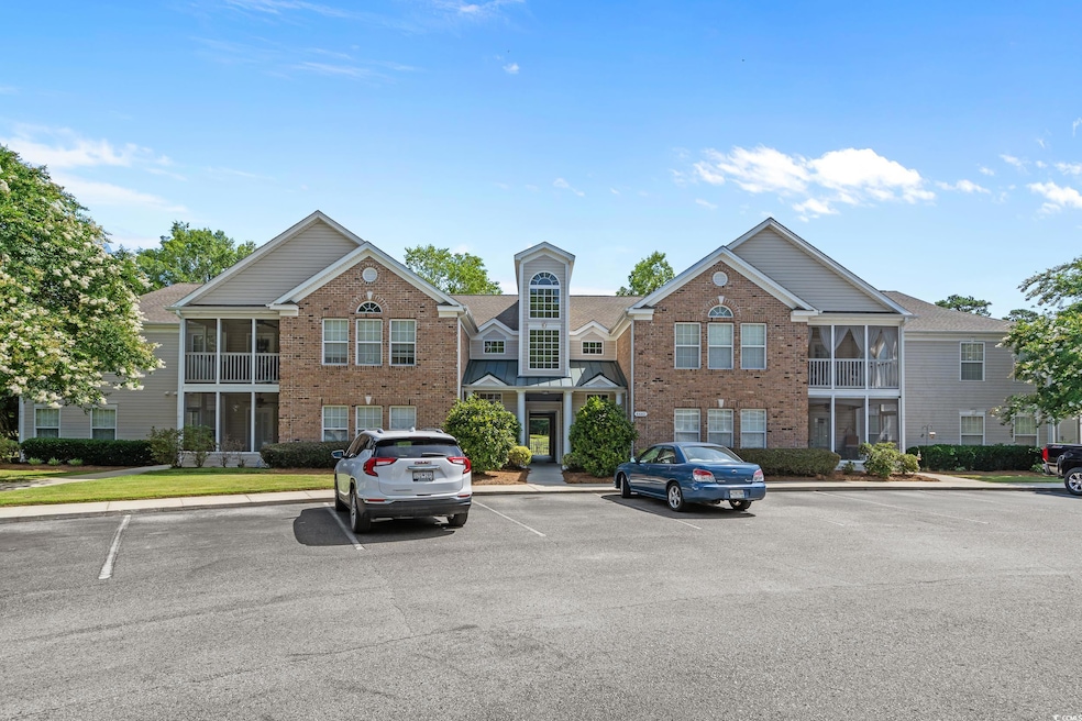 View of building exterior featuring uncovered parking