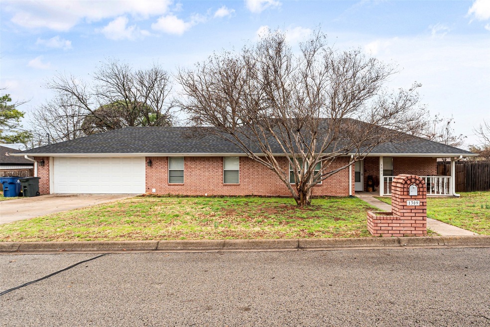 Ranch-style house with a garage and a front lawn