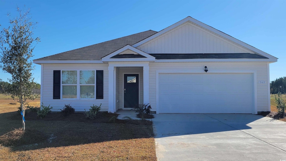 Single story home with roof with shingles, an attached garage, and concrete driveway