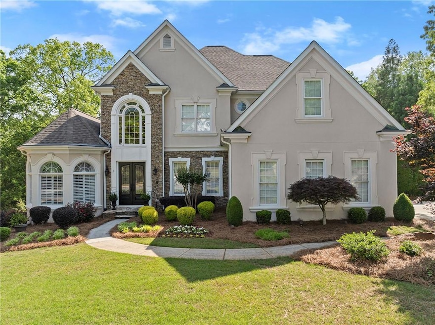 View of front of home featuring french doors, roof