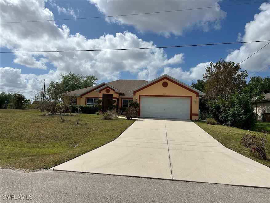 View of front of property featuring driveway, stuc