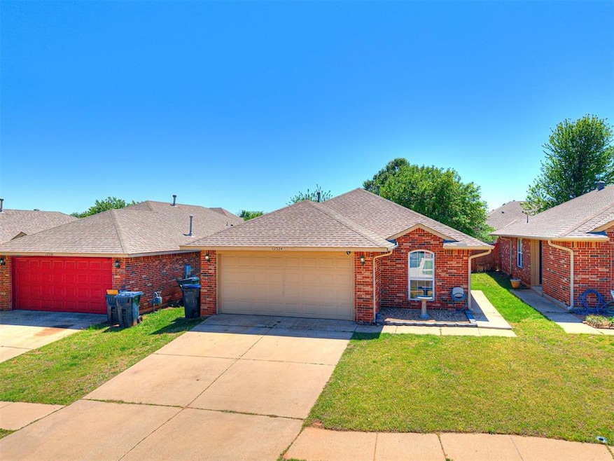 Ranch-style home featuring a front lawn, roof with
