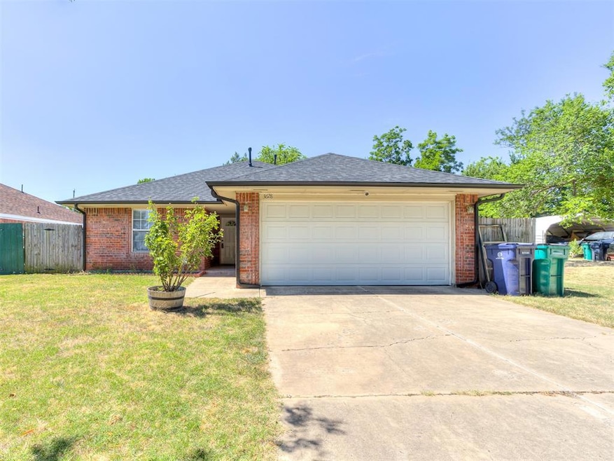 Ranch-style house featuring a garage and a front l