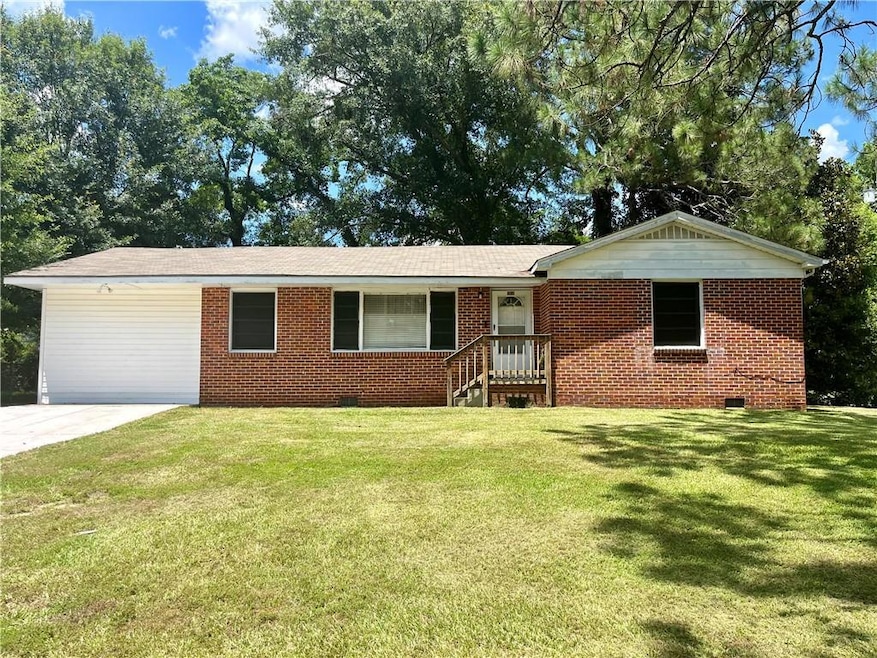 Single story home with crawl space, brick siding, and a front yard