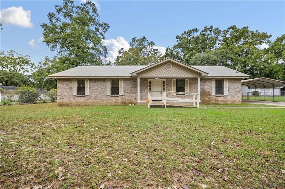 Ranch-style home featuring a porch, a front yard, 