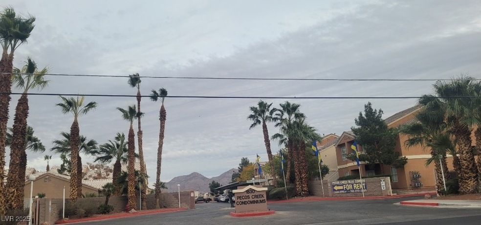 View of asphalt road with curbs and a mountain vie