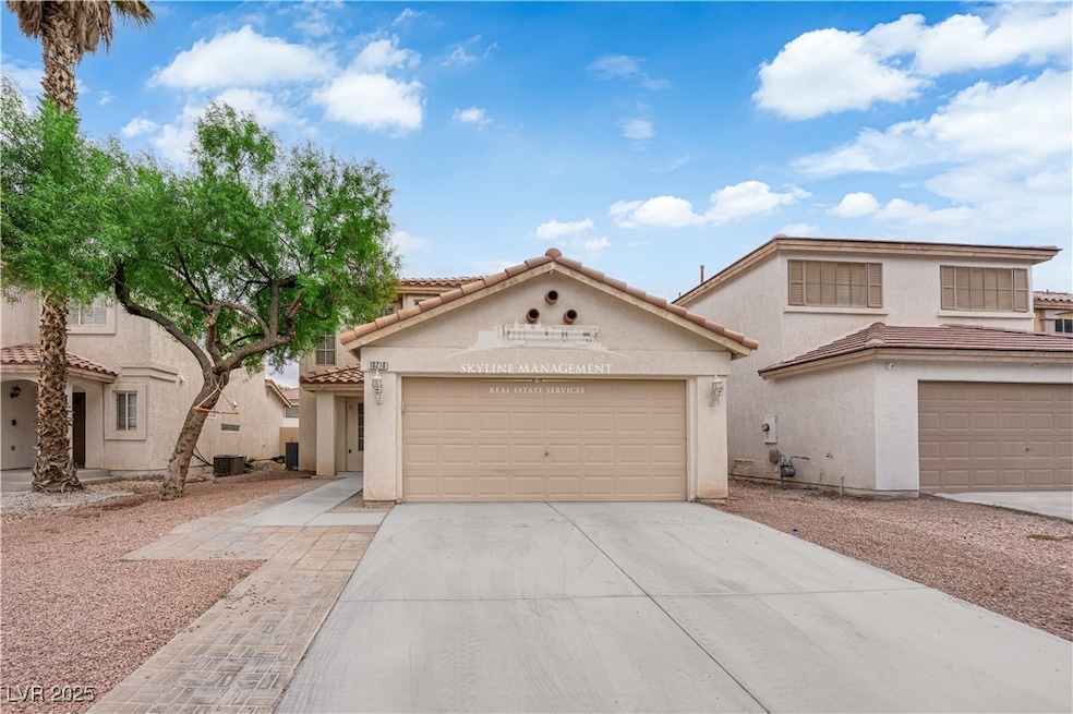 Mediterranean / spanish home featuring concrete driveway, stucco siding, an attached garage, and a tile roof
