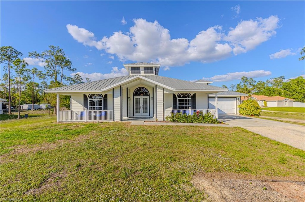 View of front facade featuring a garage, a front y