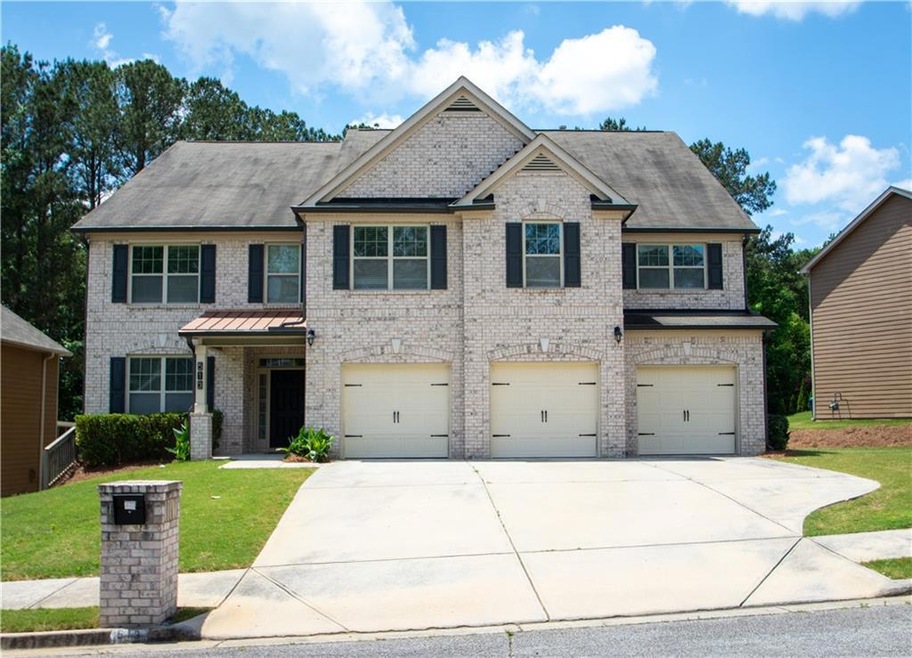 View of home's exterior featuring brick front, cov