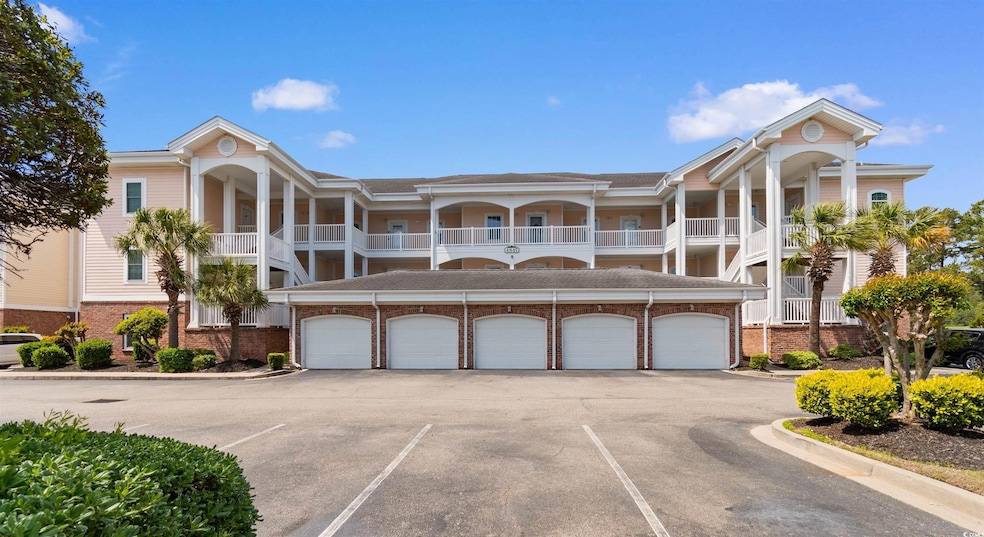 View of building exterior with uncovered parking, 