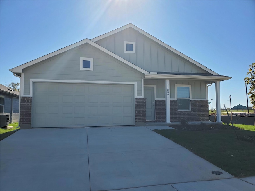 Craftsman house with brick siding, an attached gar