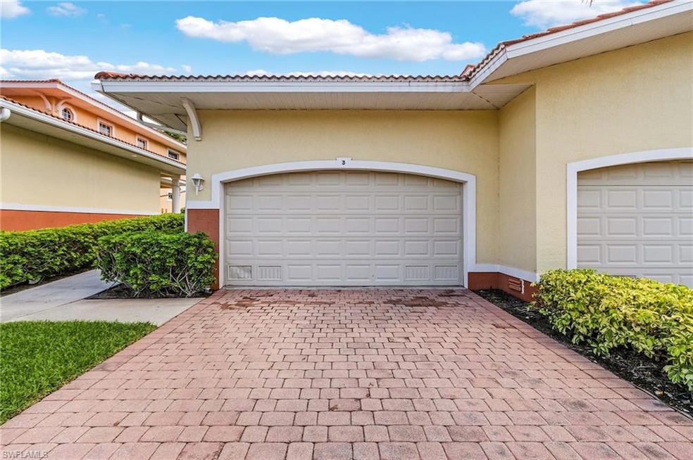 Garage featuring decorative driveway