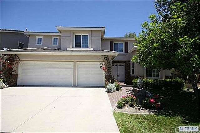 Front of home showing 3 car garage and large drive