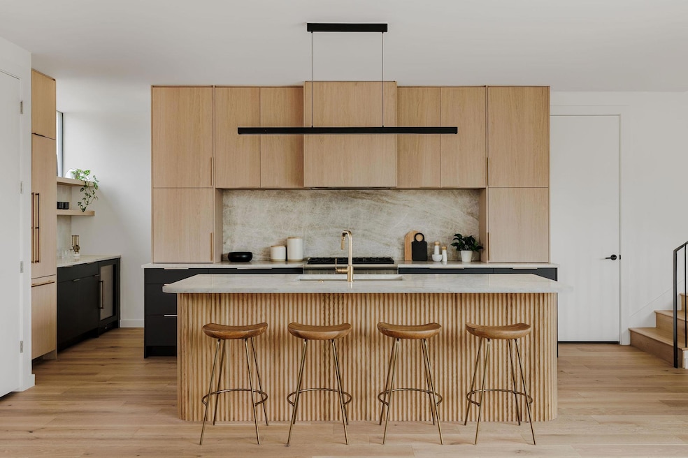 Kitchen featuring light brown cabinets, a sink, b