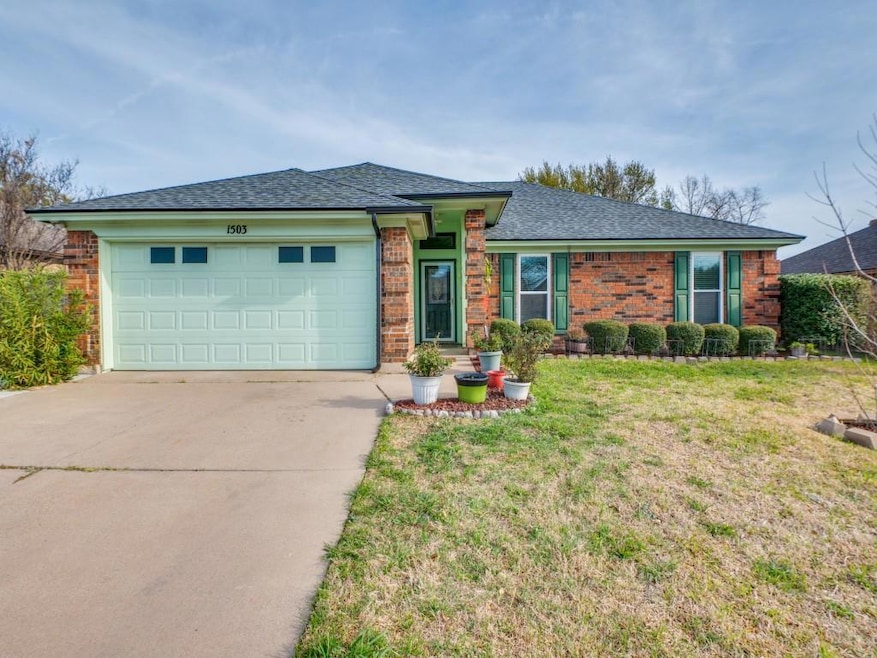 View of front of home with concrete driveway, bric