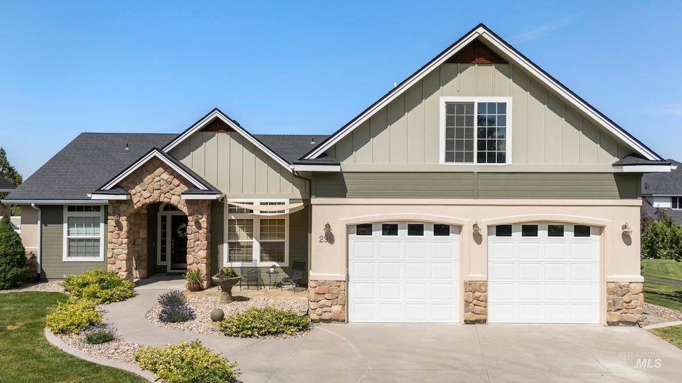 Craftsman house with stone siding, board and batten siding, driveway, and an attached garage