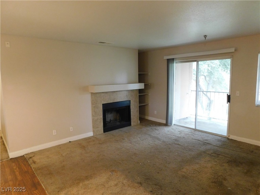 Unfurnished living room featuring built in shelves