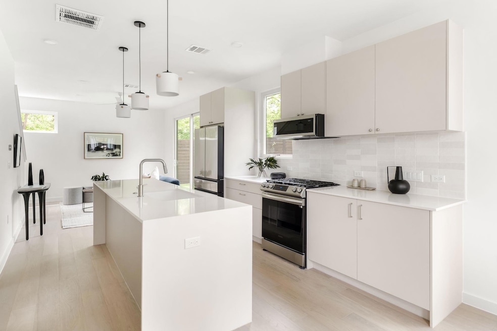 Kitchen featuring light wood finished floors, sta