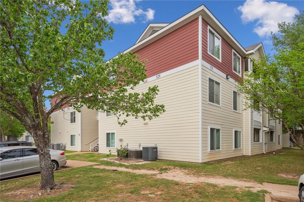 View of side of home with a lawn and central AC