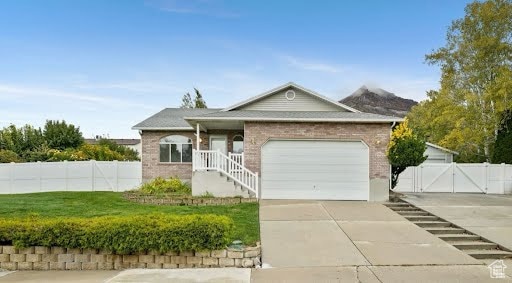 Single story home with a gate, brick siding, concrete driveway, a garage, and a porch