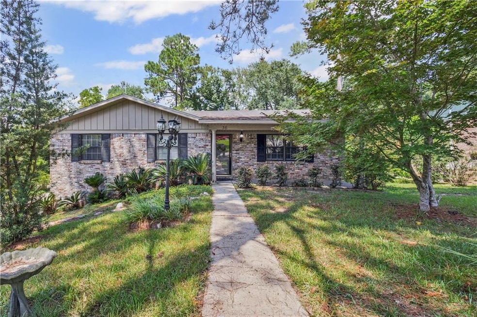 View of front of home featuring brick siding and a front yard