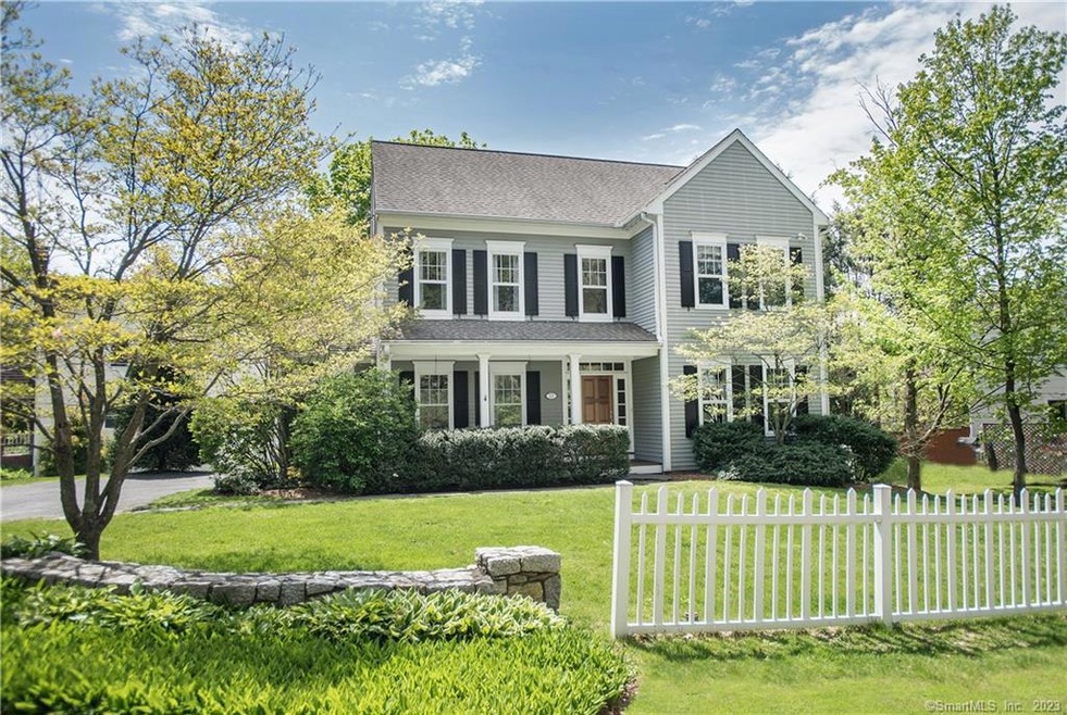 Front of House with Classic Stone Walls and Fence