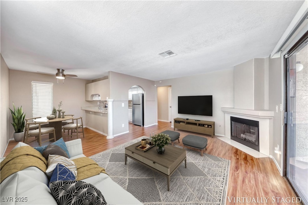Living room with wood finished floors, a ceiling f