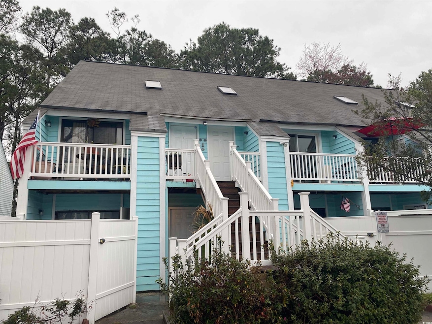 View of front of home with a shingled roof, stairs